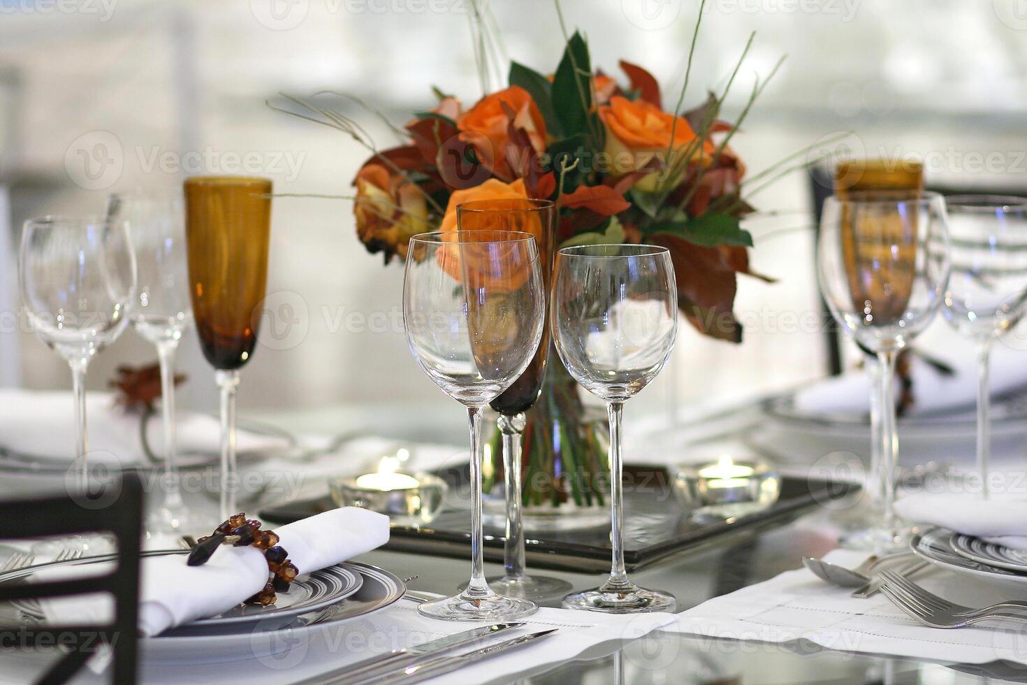 sophisticated tables with plates, cutlery and fine glasses close-up photo