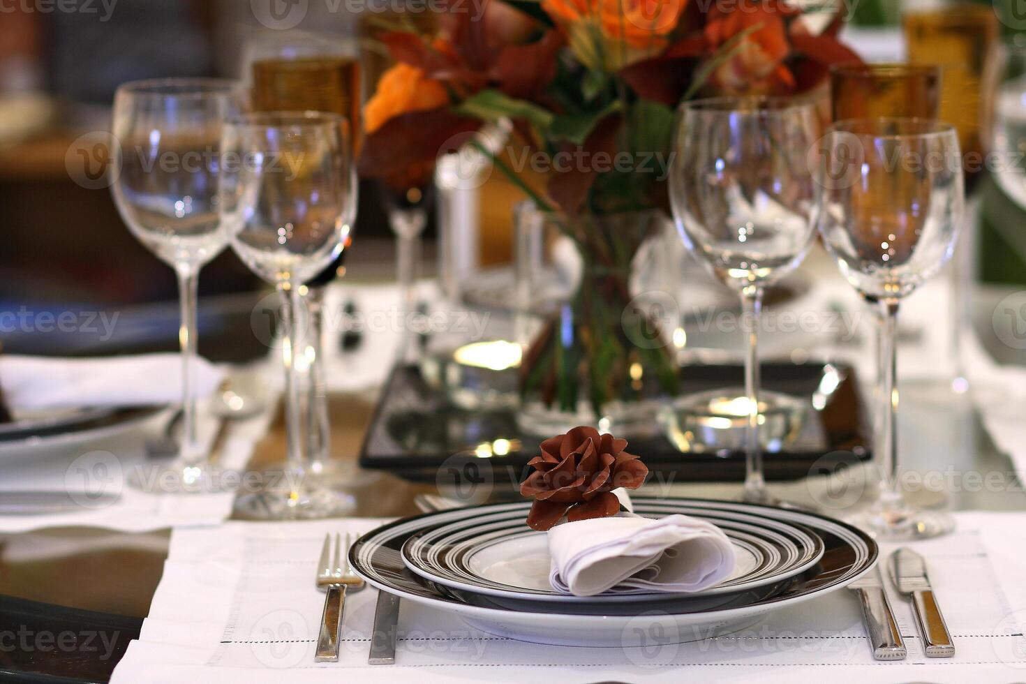 sophisticated tables with plates, cutlery and fine glasses close-up photo