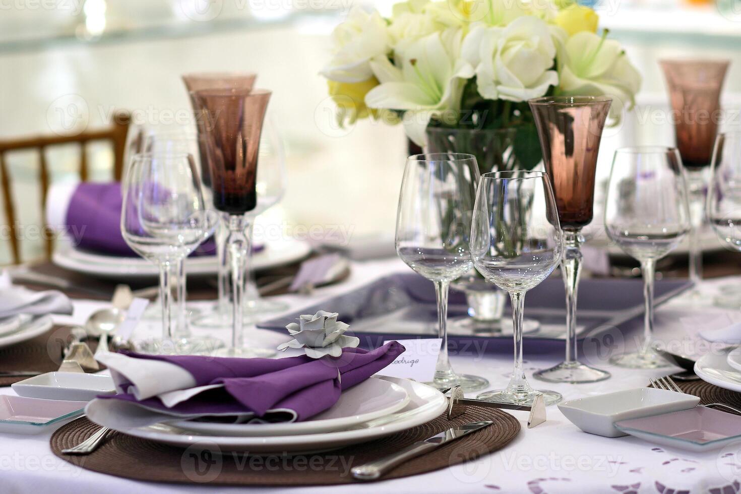 sophisticated tables with plates, cutlery and fine glasses close-up photo