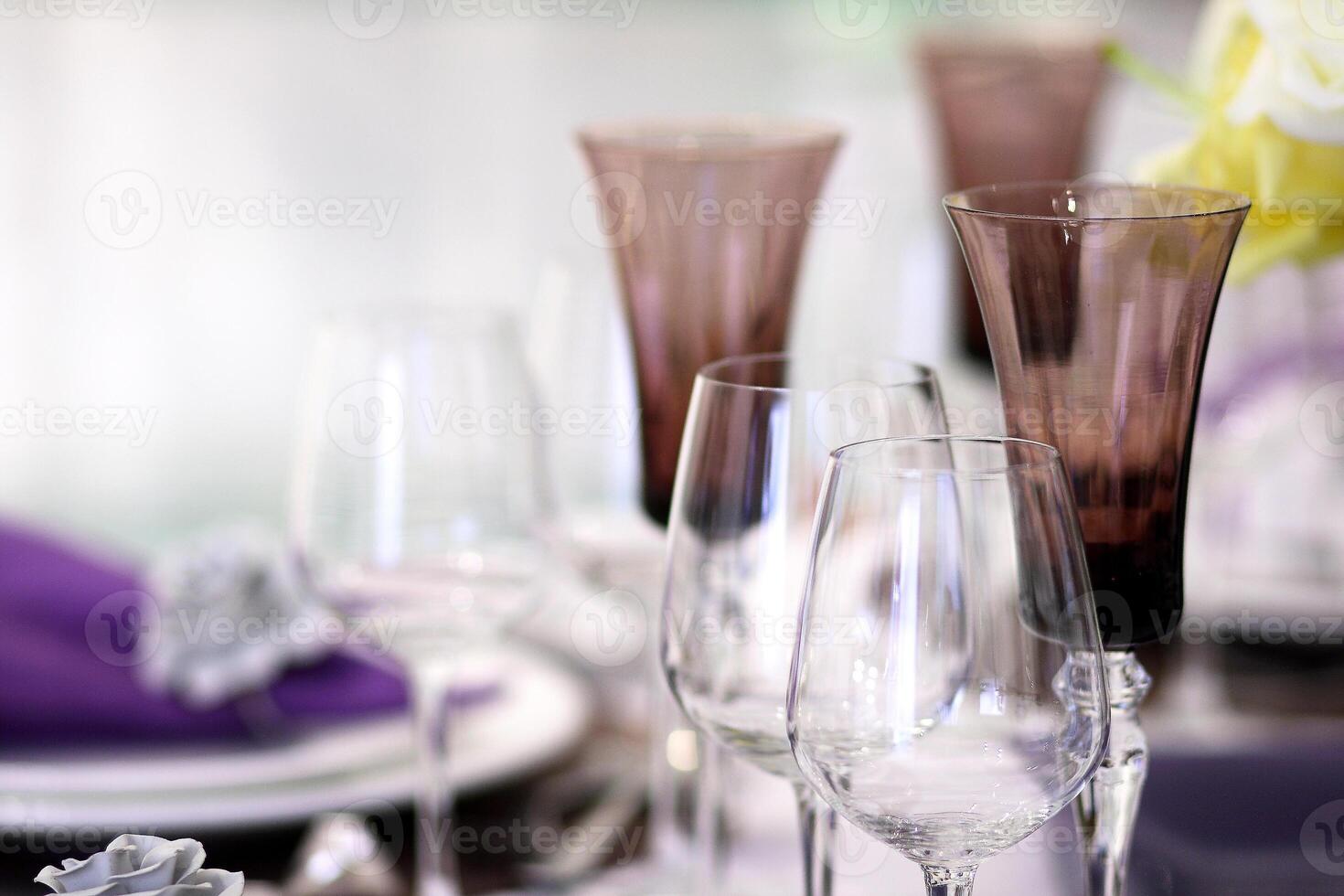 sophisticated tables with plates, cutlery and fine glasses close-up photo
