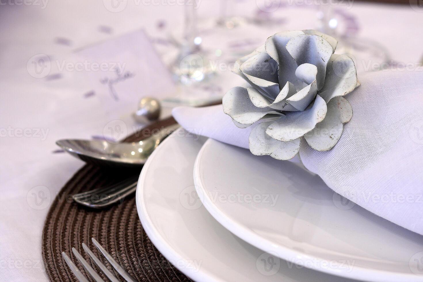 sophisticated tables with plates, cutlery and fine glasses close-up photo