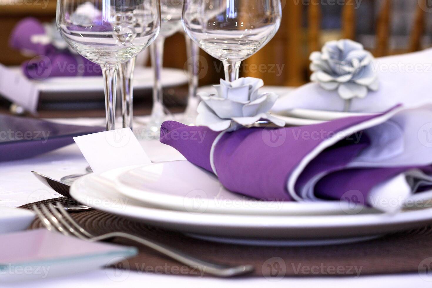 sophisticated tables with plates, cutlery and fine glasses close-up photo