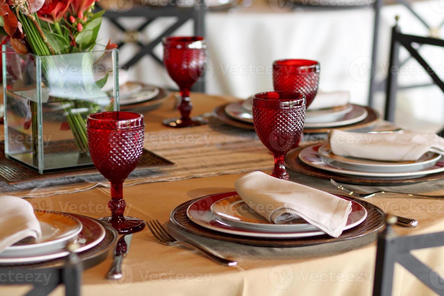 sophisticated table arrangements with red jackfruit glasses photo