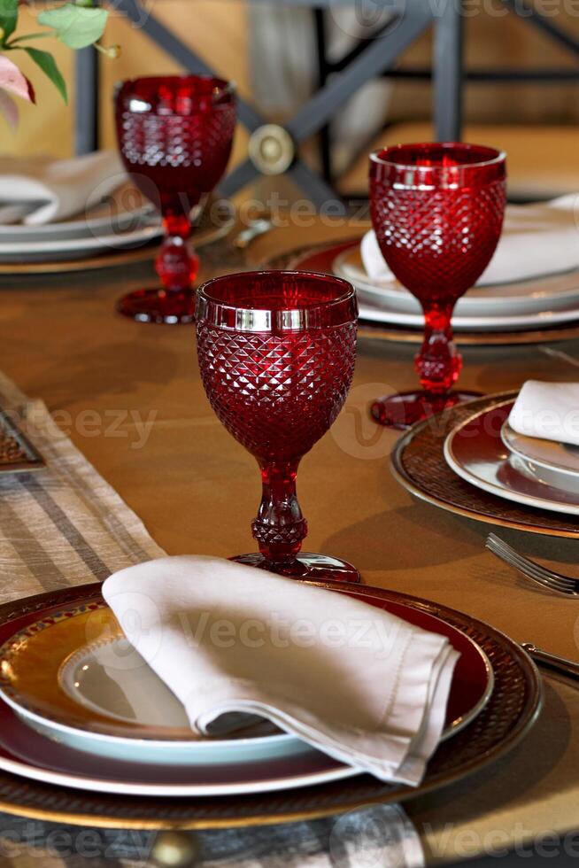 sophisticated table arrangements with red jackfruit glasses photo