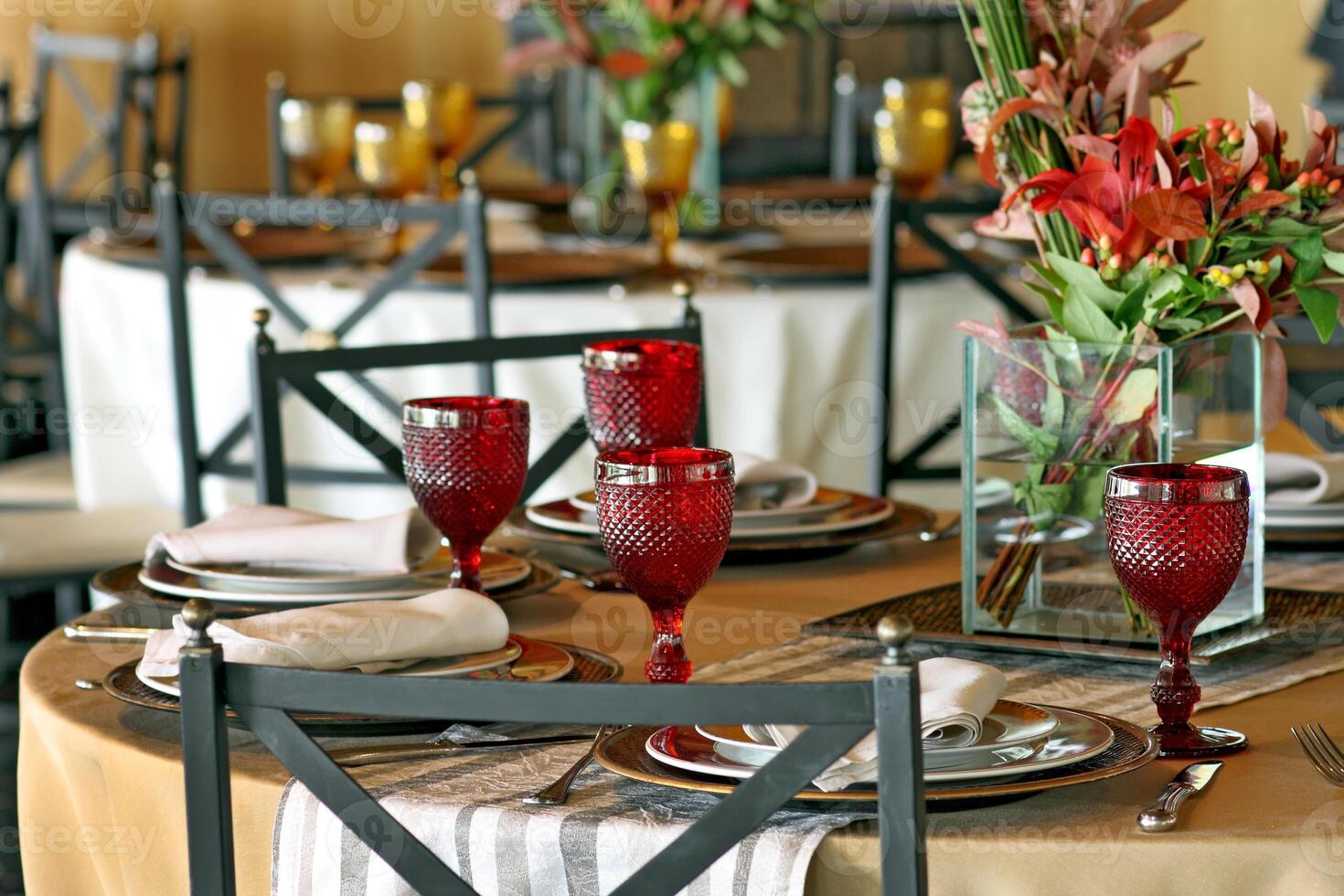 sophisticated table arrangements with red jackfruit glasses photo