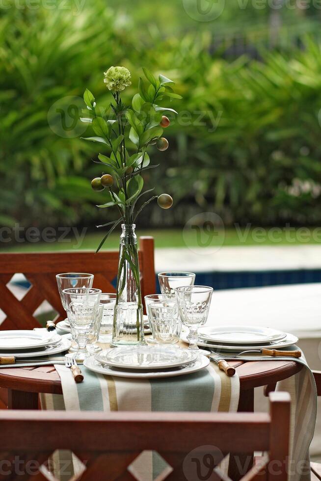 creative and informal table set up outside the house with all the details photo