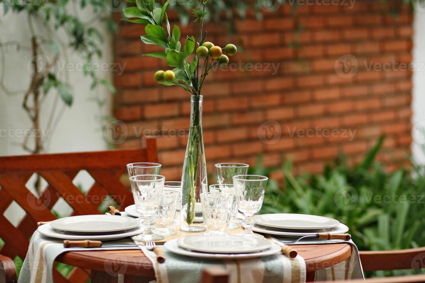 creative and informal table set up outside the house with all the details photo