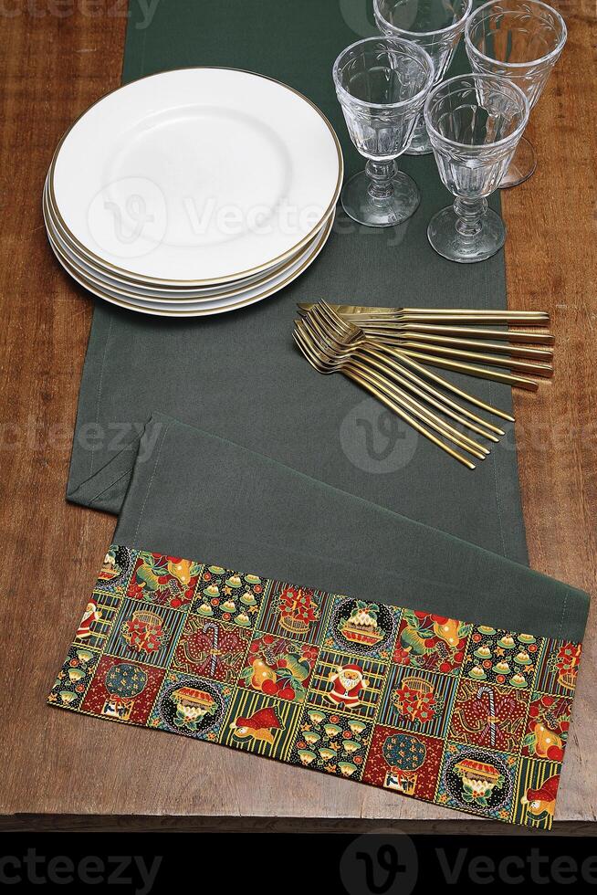assembly with tablecloths, bowls, plates and glasses for the Christmas table photo