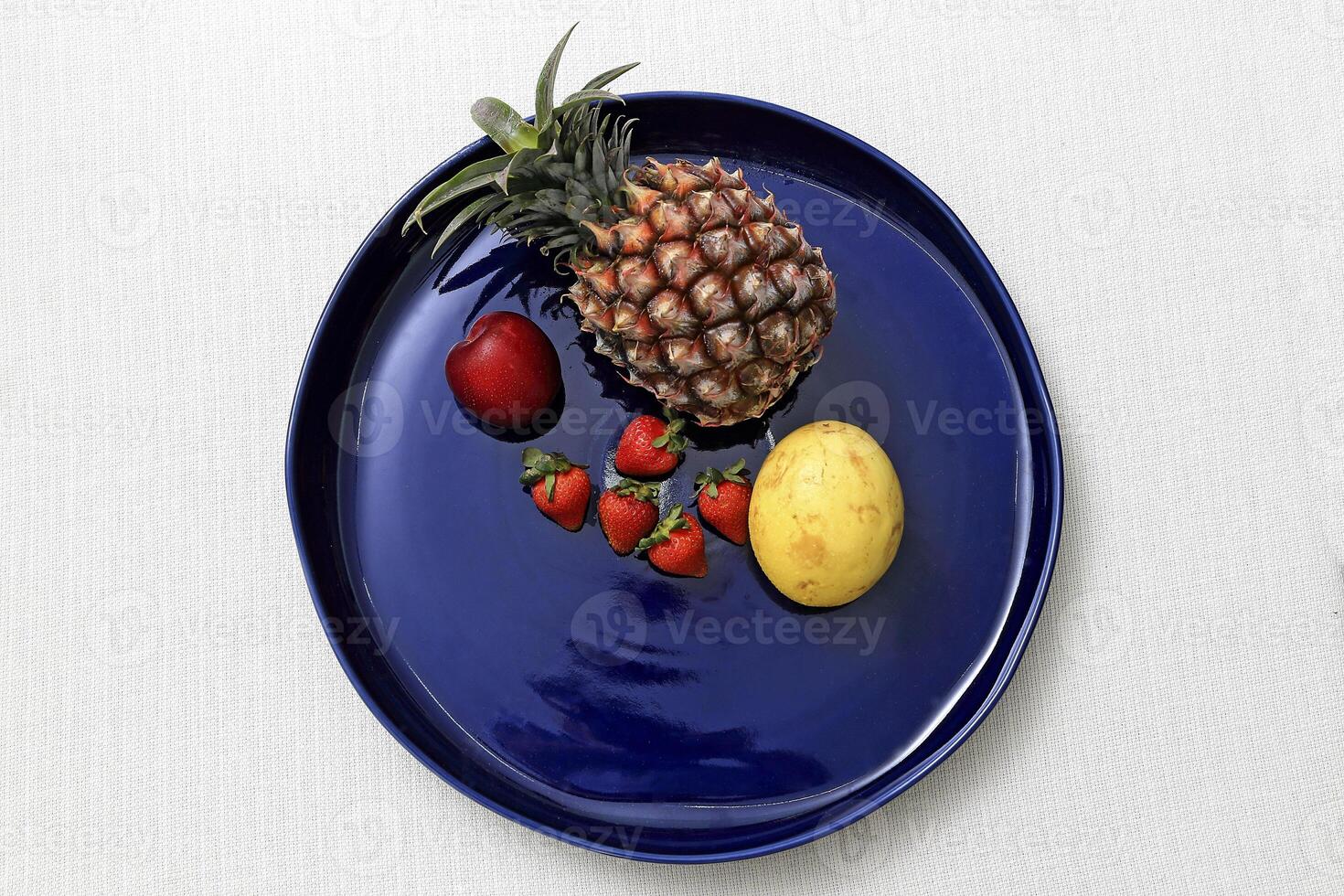 blue ceramic plate with several different fruits photo