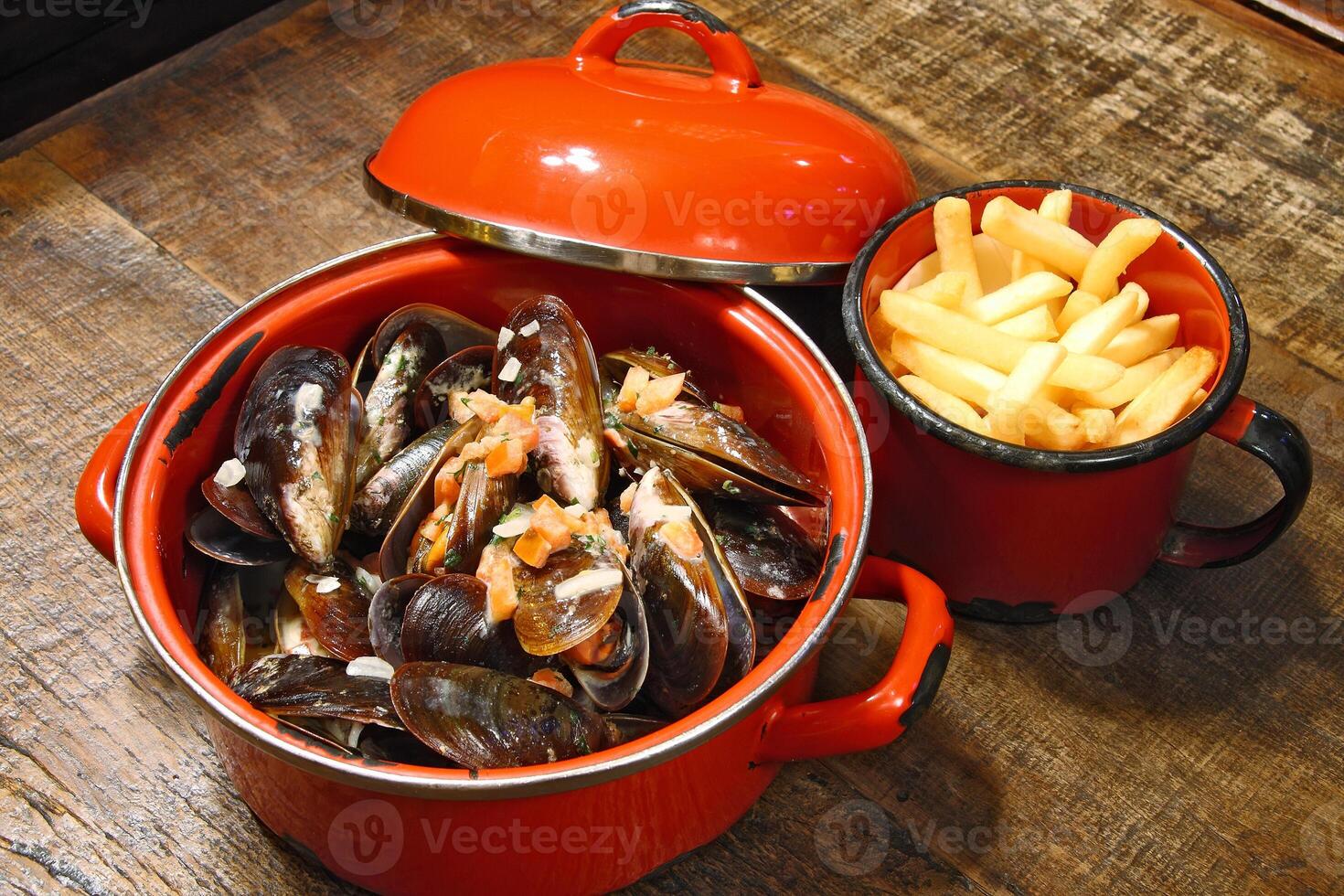 mussels in vinaigrette sauce in red pan photo