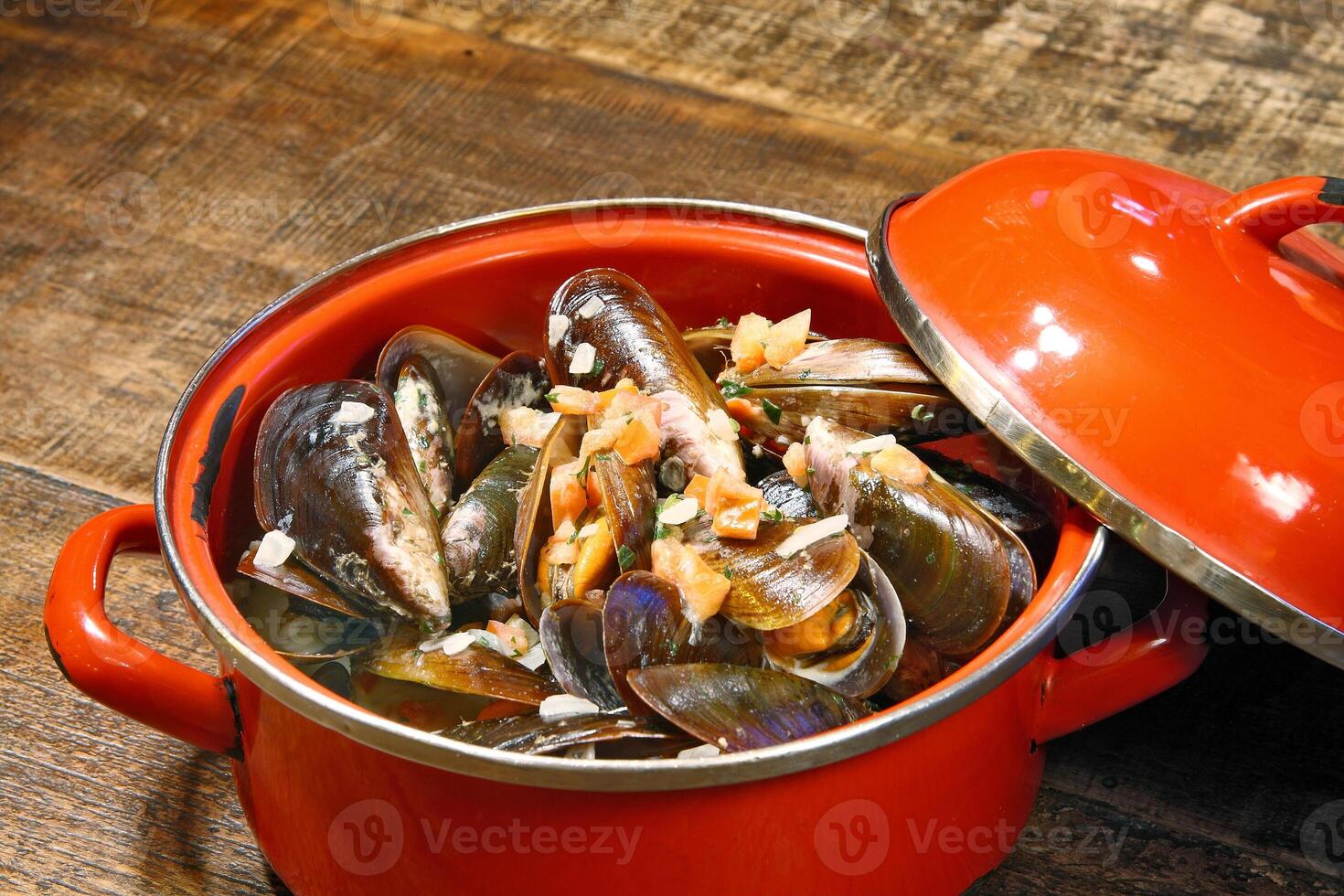 mussels in vinaigrette sauce in red pan photo