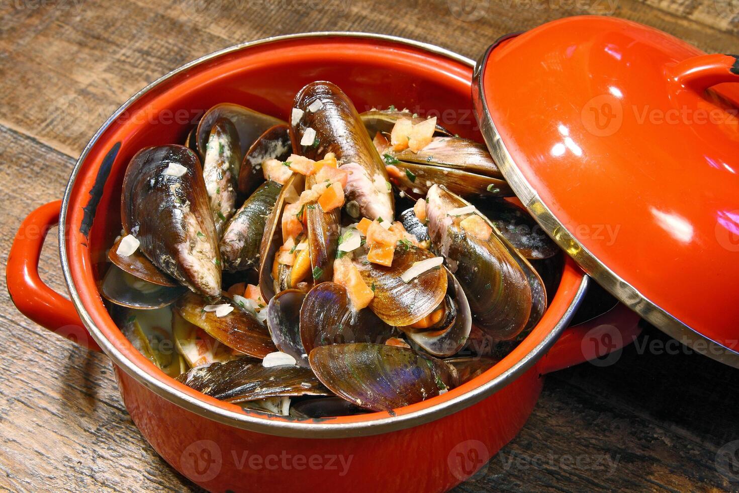 mussels in vinaigrette sauce in red pan photo