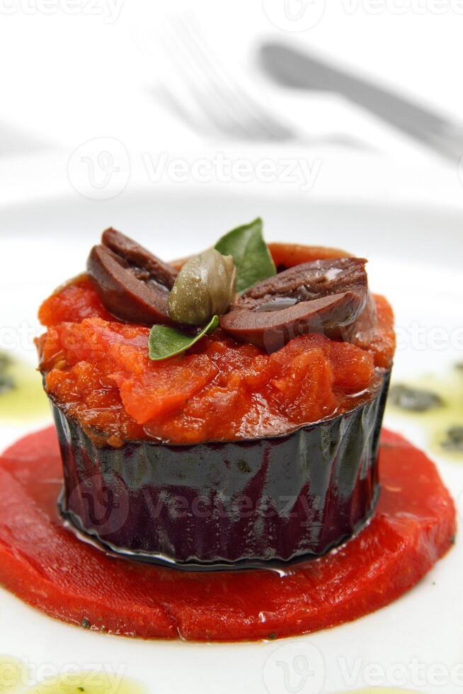 eggplant with anchovies and olives and tomato sauce photo