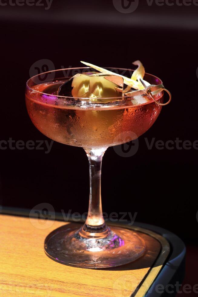 Cardinale, delicious drink with gin, red bitter liqueur and dry vermouth in a glass with ice photo