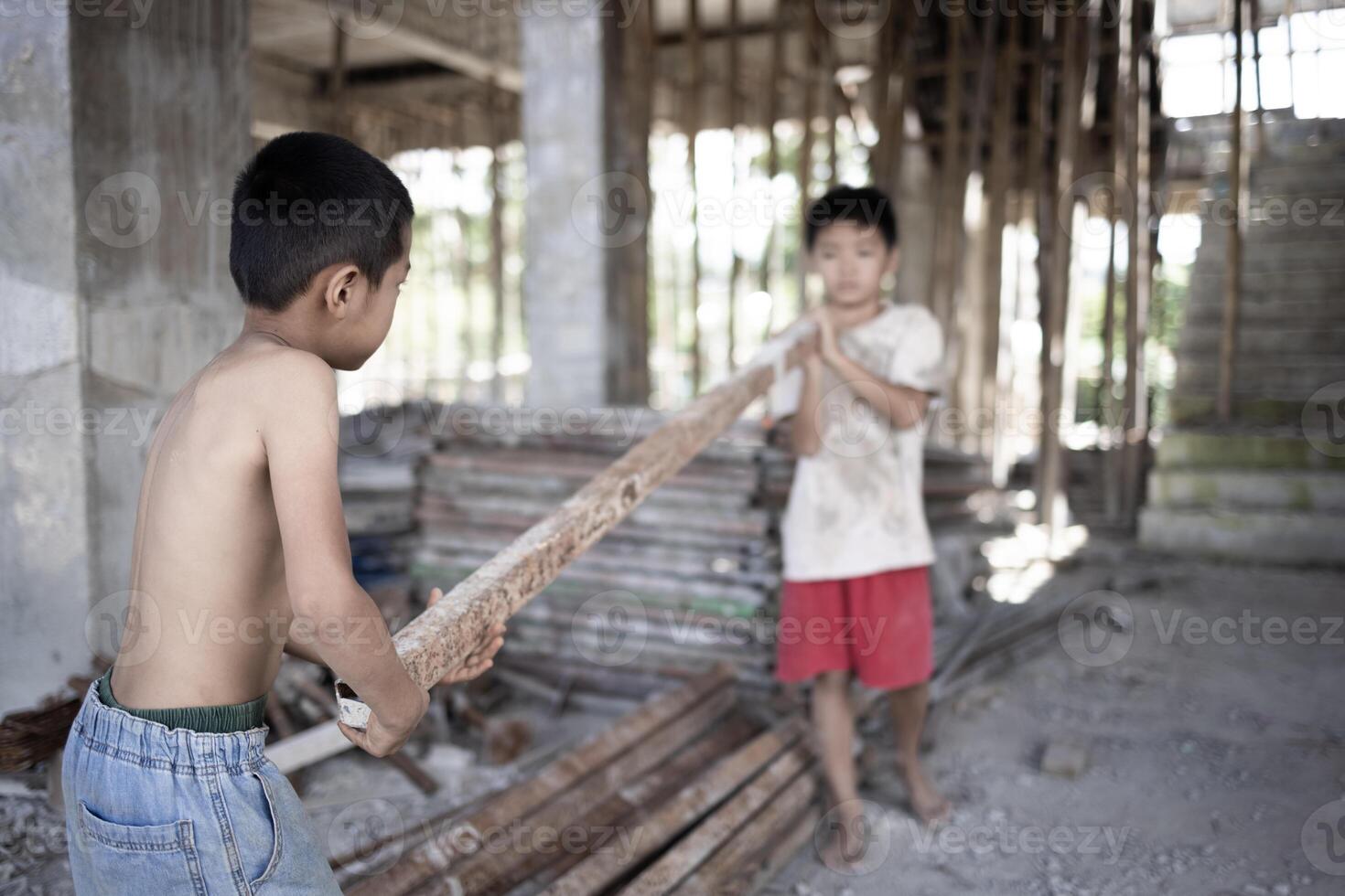 Poor children at the construction site were forced to work. Concept against child labor. The oppression or intimidation of forced labor among children. Human trafficking. photo