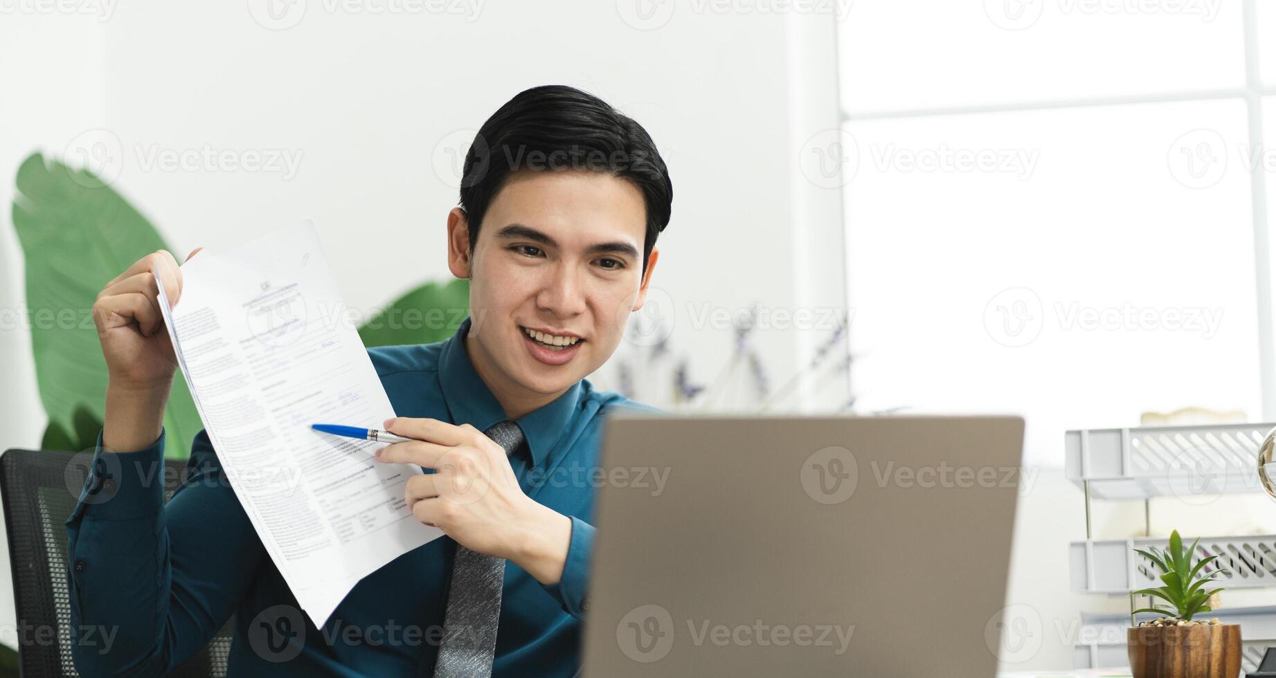 Image of Asian male businessman working in the office photo