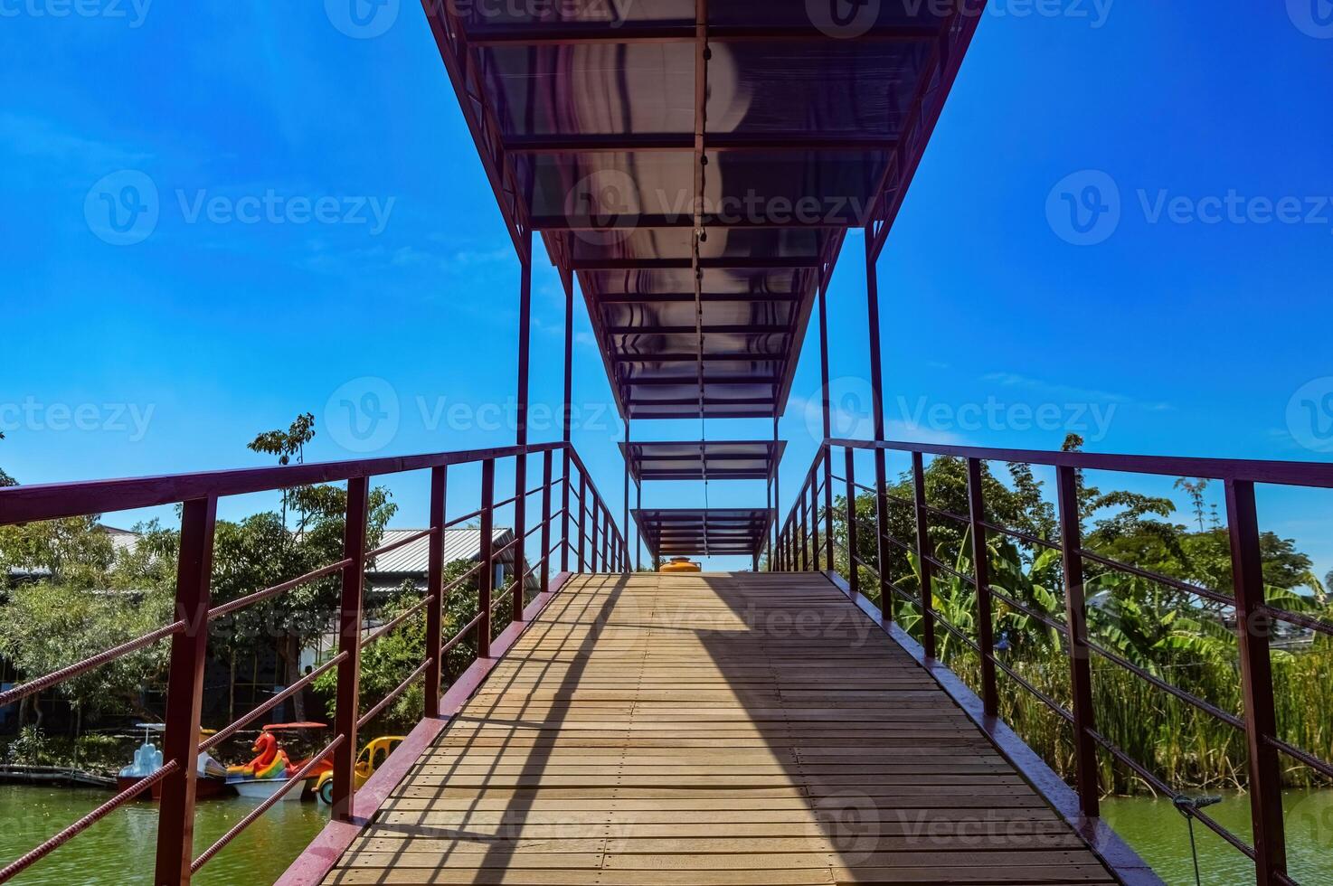 an iron-framed bridge for pedestrians in a park photo