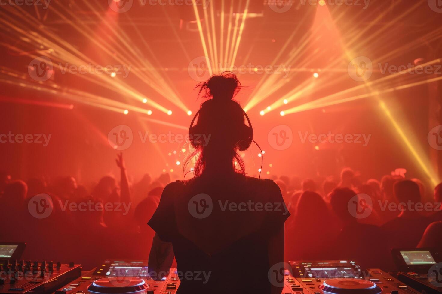 Female DJ on a big rave playing for a big crowd of party people, ravers dancing, big laser show photo