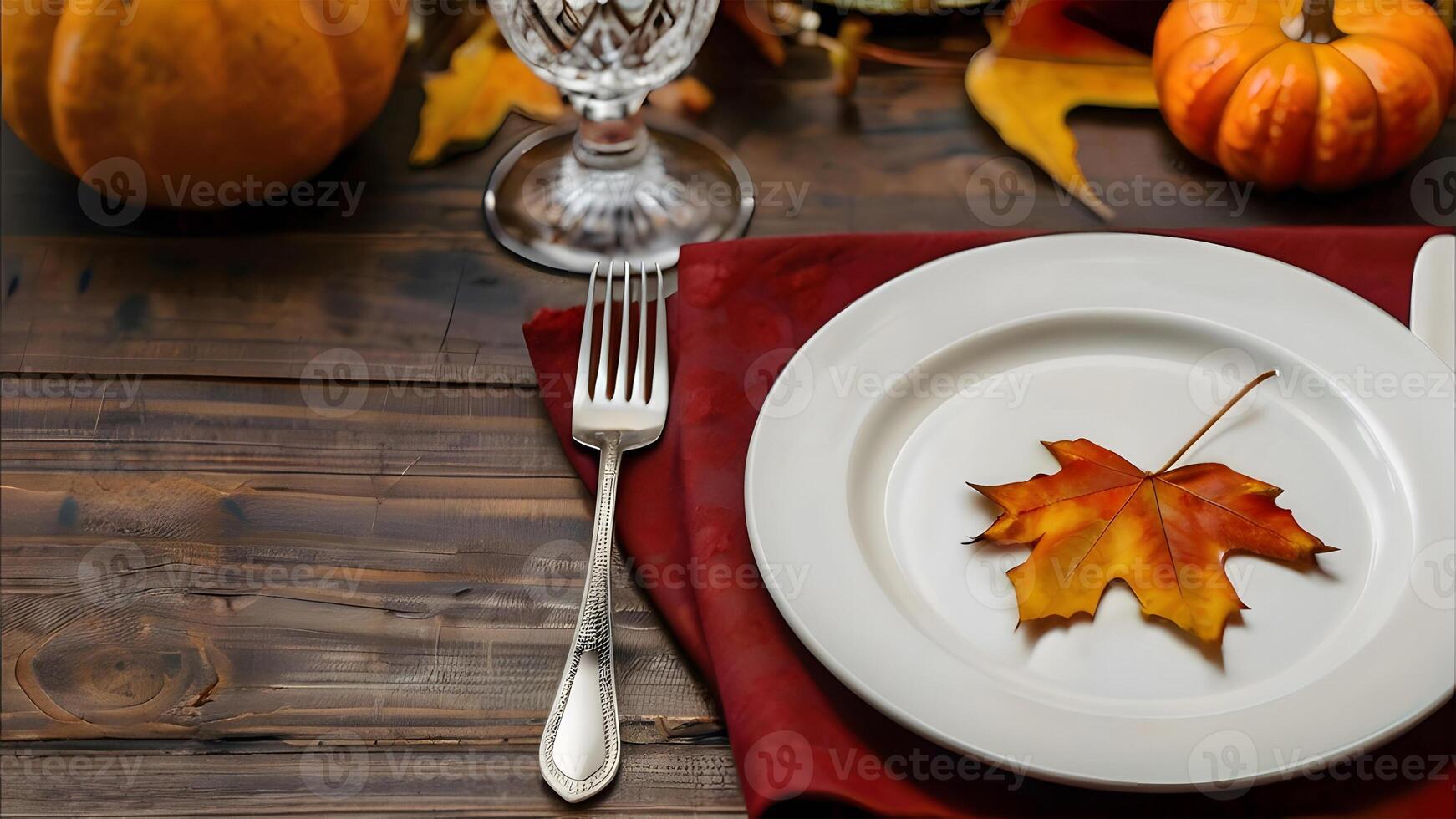 Thanksgiving autumn table setting with pumpkin and fall leaves on a rustic wooden table. Top view. photo
