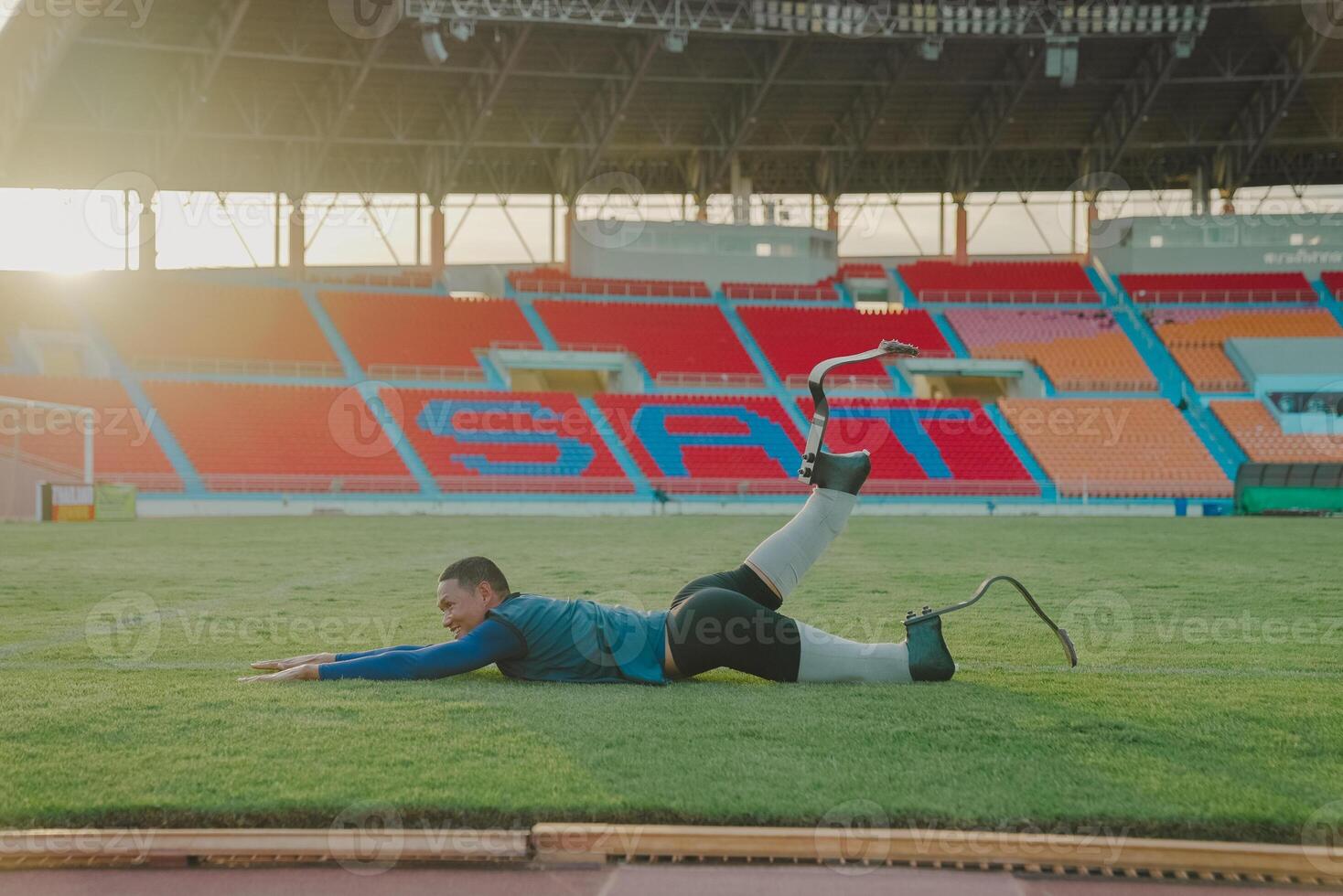 Asian para-athlete runner prosthetic leg on the track alone outside on a stadium track Paralympic running concept. photo