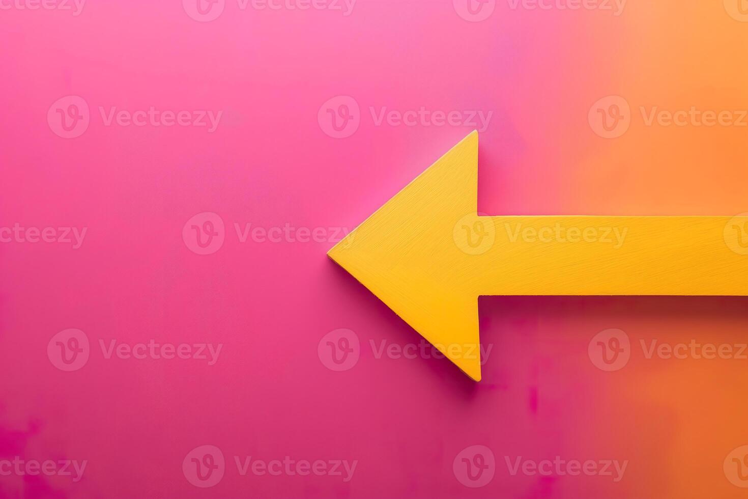 A yellow arrow pointing to the right against a pink background. photo