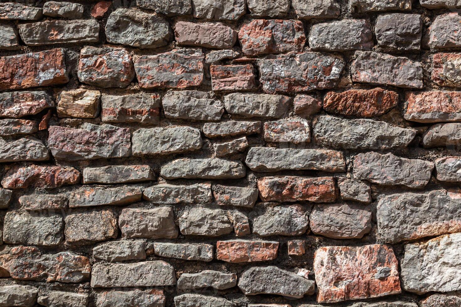 Stone texture of a wall in Montenegro. An ancient wall made of brown coloured stones. Background. Template. For design. Horizontal. photo