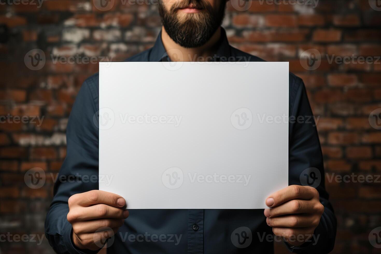 a middle-aged man holds a sheet of white paper mockup in his hands. photo