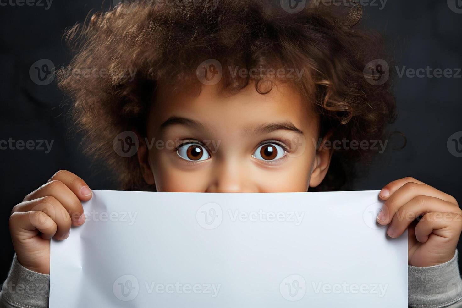 Funny child boy hiding behind blank white advertising billboard with copy space and peeking out . photo