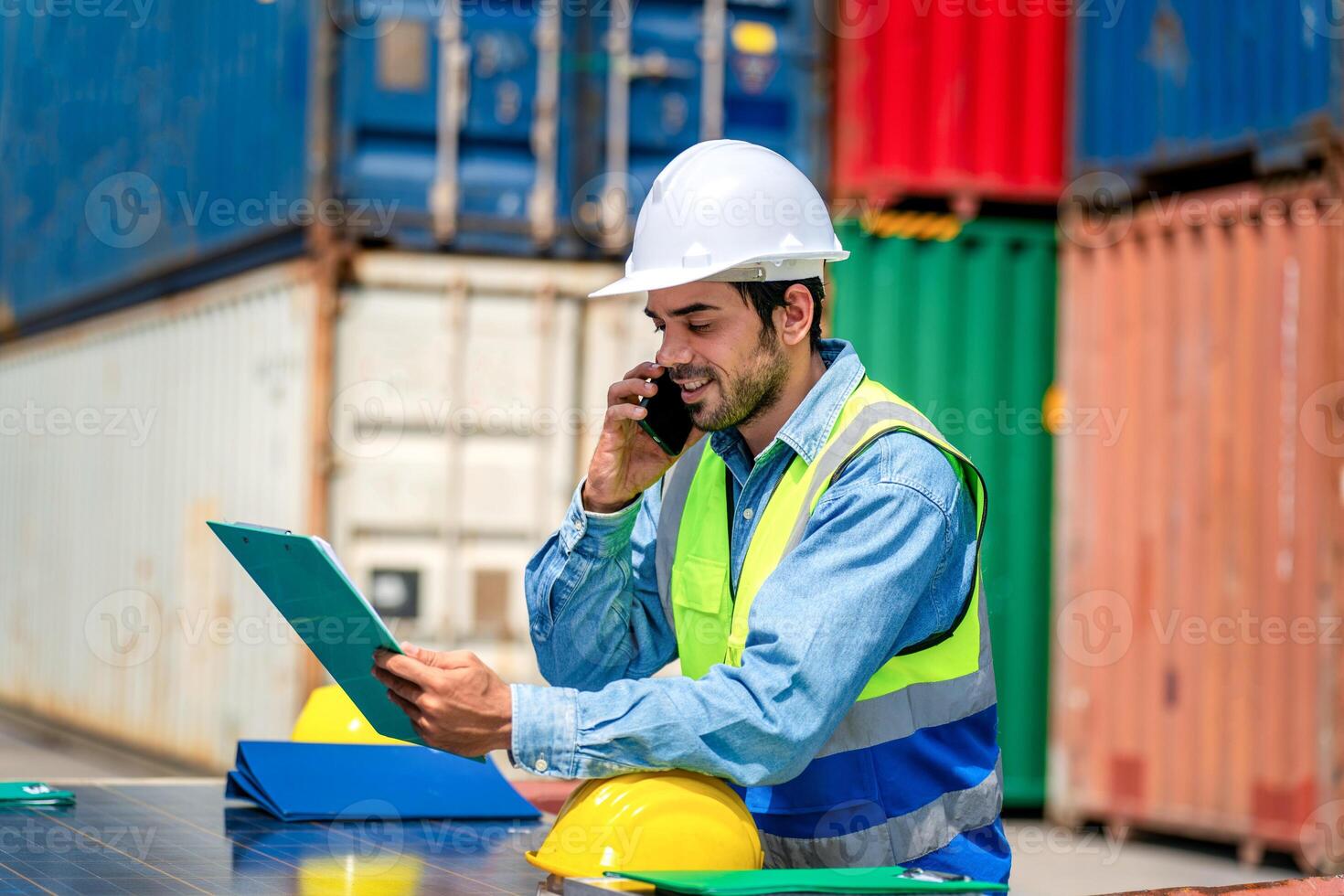 Engineer wears PPE checking container storage with cargo container background at sunset. Logistics global import or export shipping industrial concept. photo
