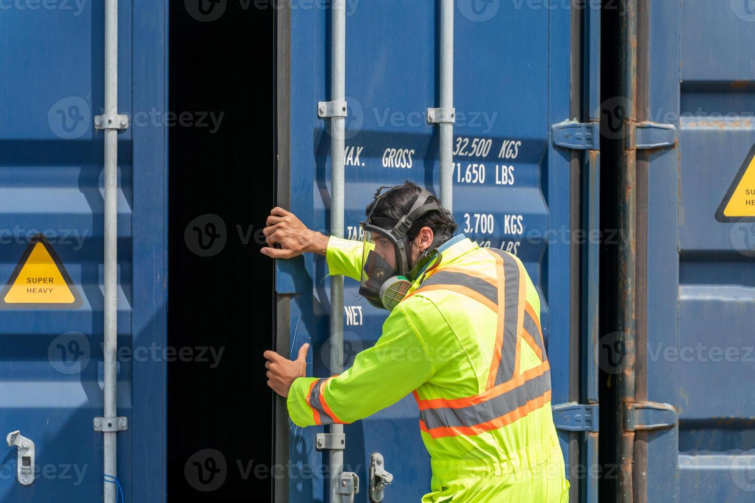 Engineer wear PPE urgently assisted the male technique inside container as Chemical spill in the container shipping industry photo