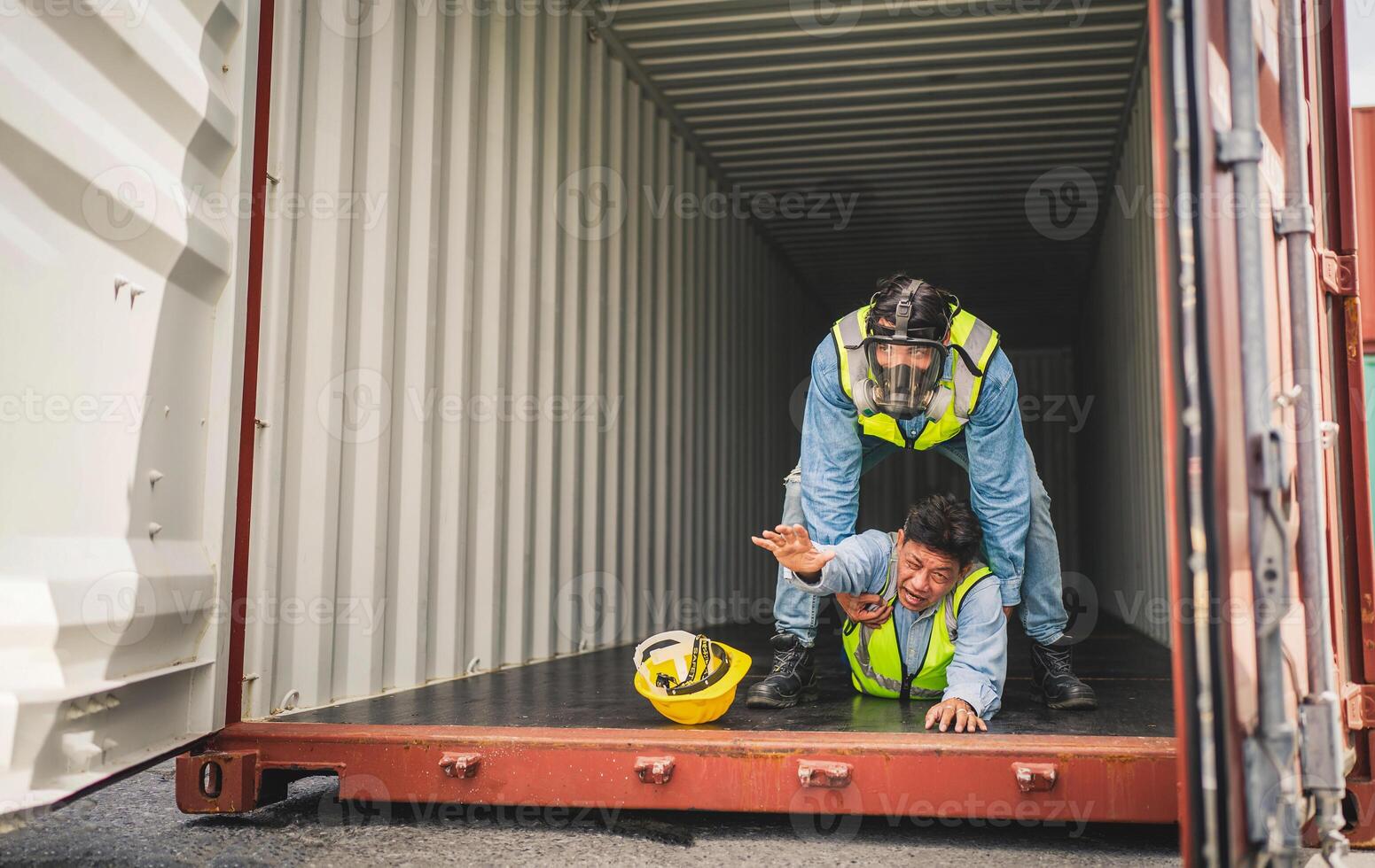 Engineer wear PPE urgently assisted the male technique inside container as Chemical spill in the container shipping industry photo