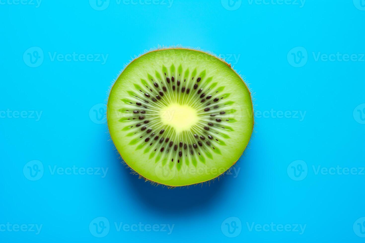 Kiwi slice isolated on a blue background, top view photo