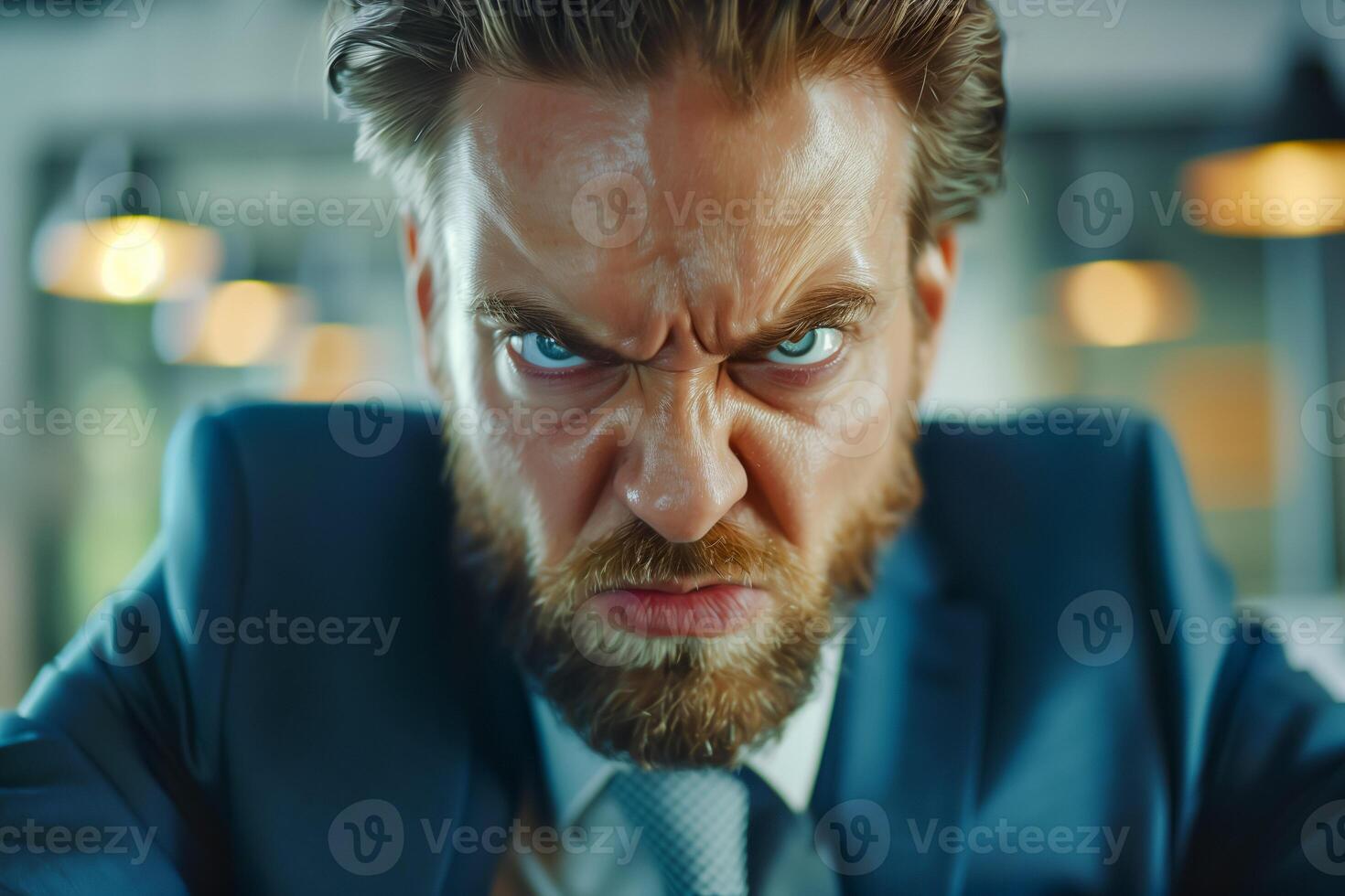 Angry young boss in the office. Furious businessman, closeup. photo