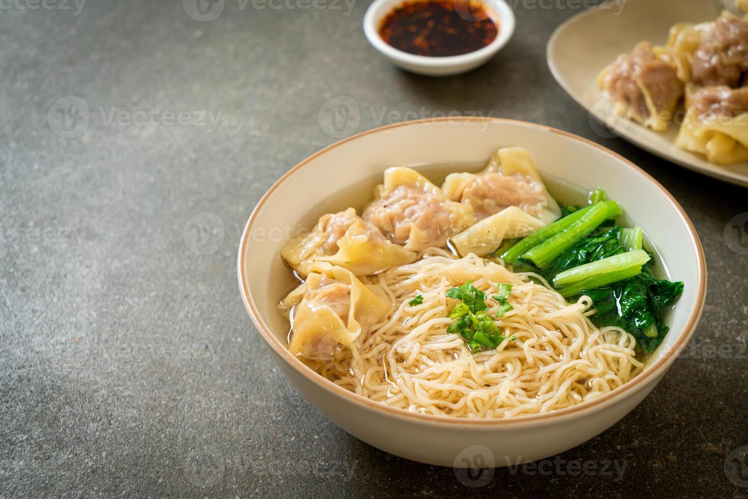 egg noodles with pork wonton soup or pork dumplings soup and vegetable photo