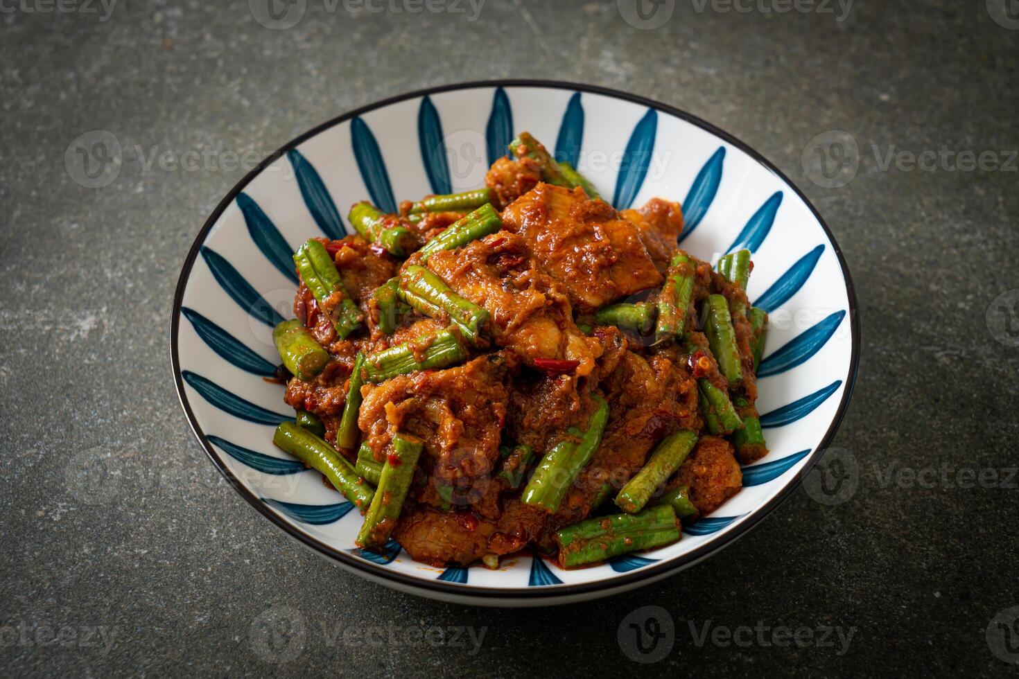 Stir fried pork with red curry paste photo