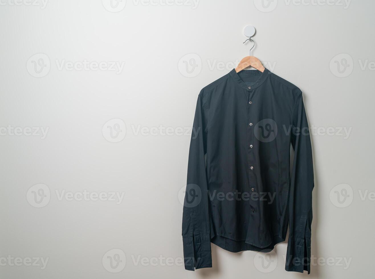 hanging shirt with wood hanger on wall photo