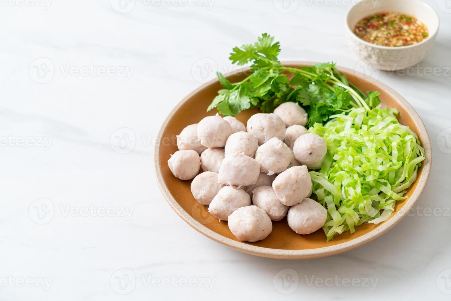 pork meatball with vegetable and spicy sauce photo