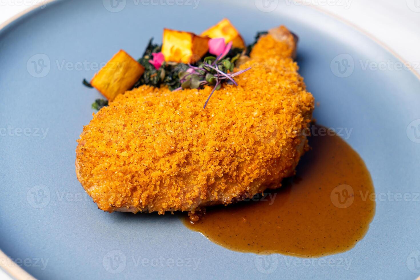 fried chicken thigh with vegetable and sauce photo