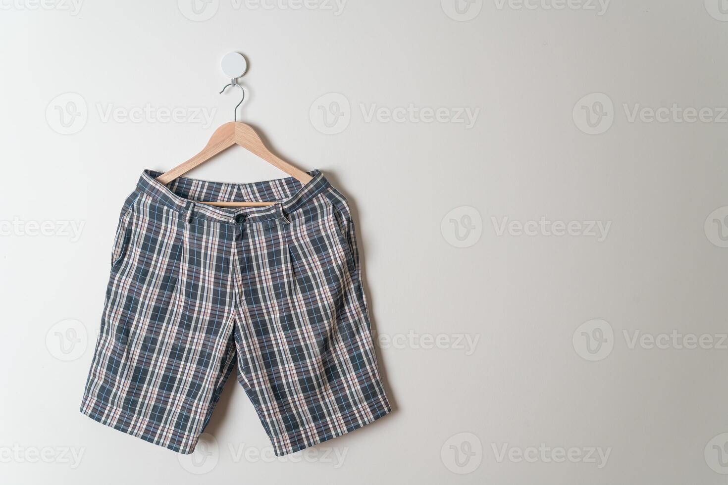 short pants hanging on wall photo