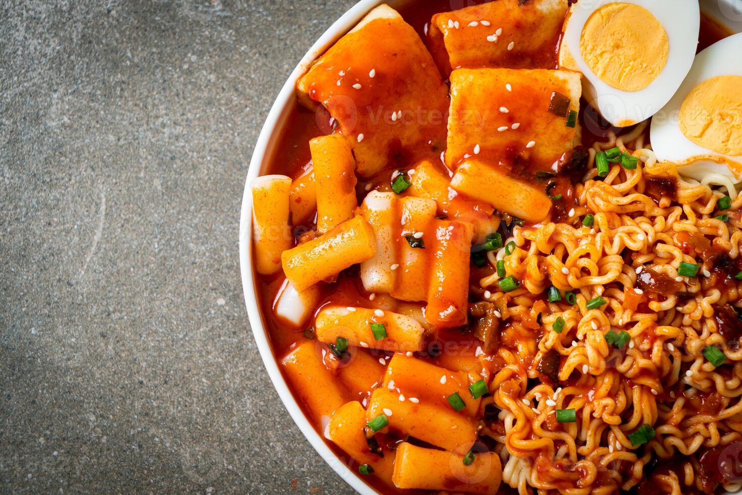 Korean instant noodles with Korean rice cake and fish cake and boiled egg photo