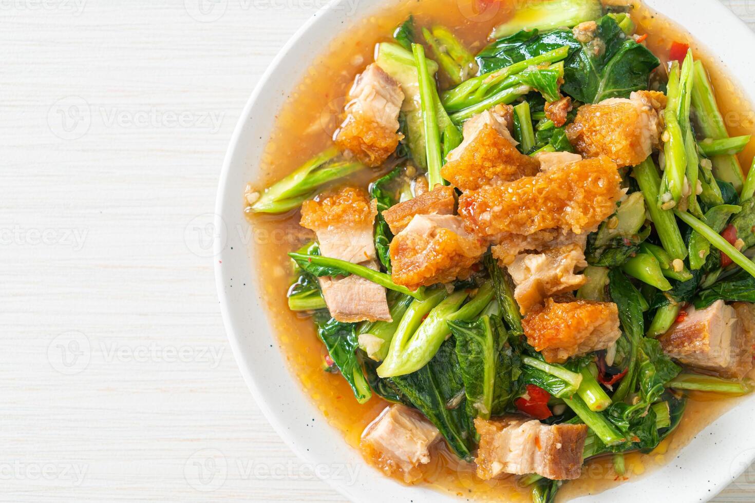 Stir-fried kale vegetable with crispy pork photo