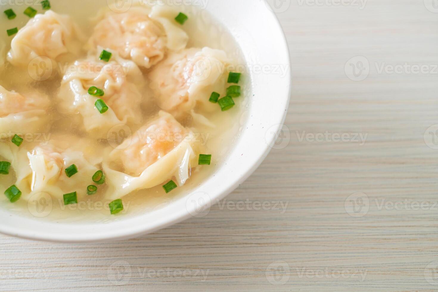 shrimp dumpling soup in white bowl photo