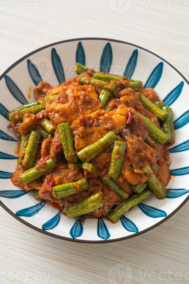 Stir fried pork with red curry paste photo
