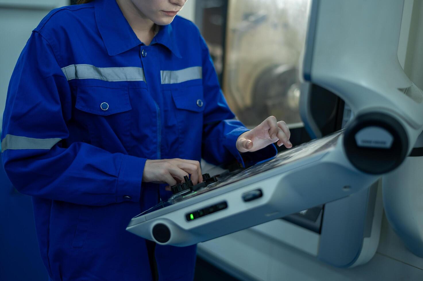 Female Robotics engineers Using Controller to Remotely Operate programming and Manipulating Robot Hand, Industrial Robotics Design, High Tech Facility, Modern Machine Learning. photo