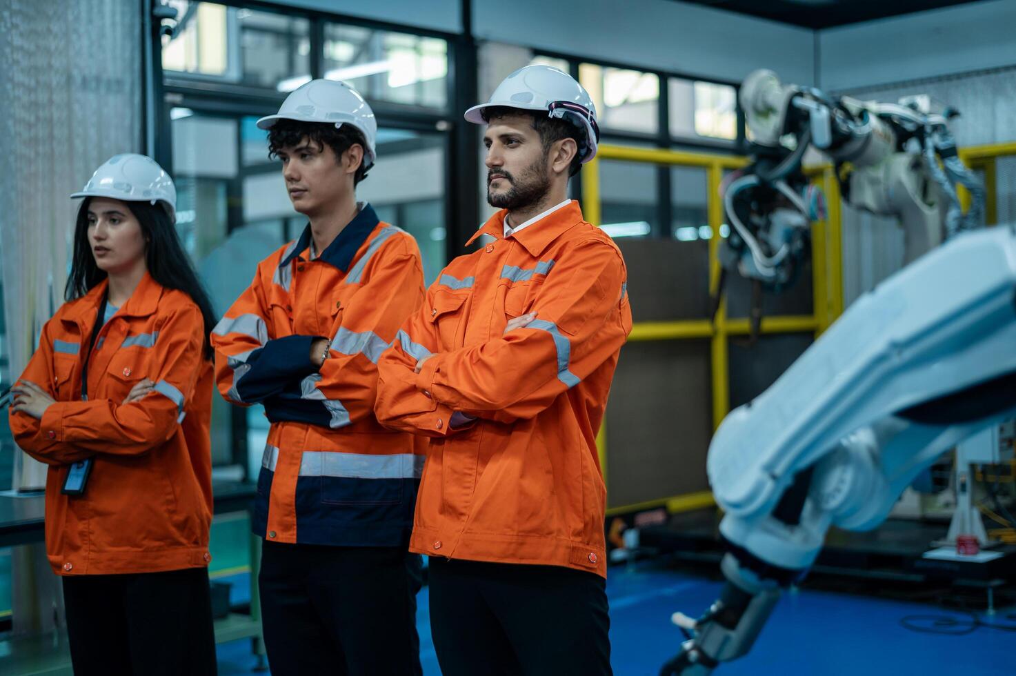 Portrait of Robotics engineers working with Programming and Manipulating Robot Hand, Industrial Robotics Design, High Tech Facility, Modern Machine Learning. Mass Production Automatics. photo