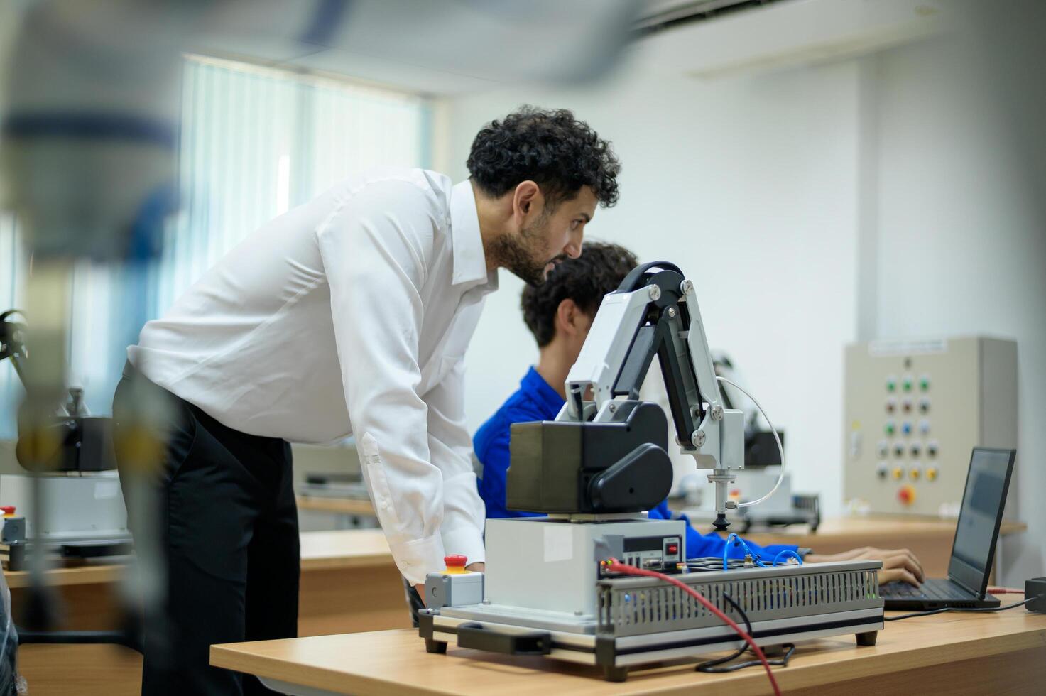 aprendiz robótica ingeniero aprendizaje con programación y manipulando robot mano, industrial robótica diseño, alto tecnología instalación, moderno máquina aprendiendo. masa producción automáticas. foto