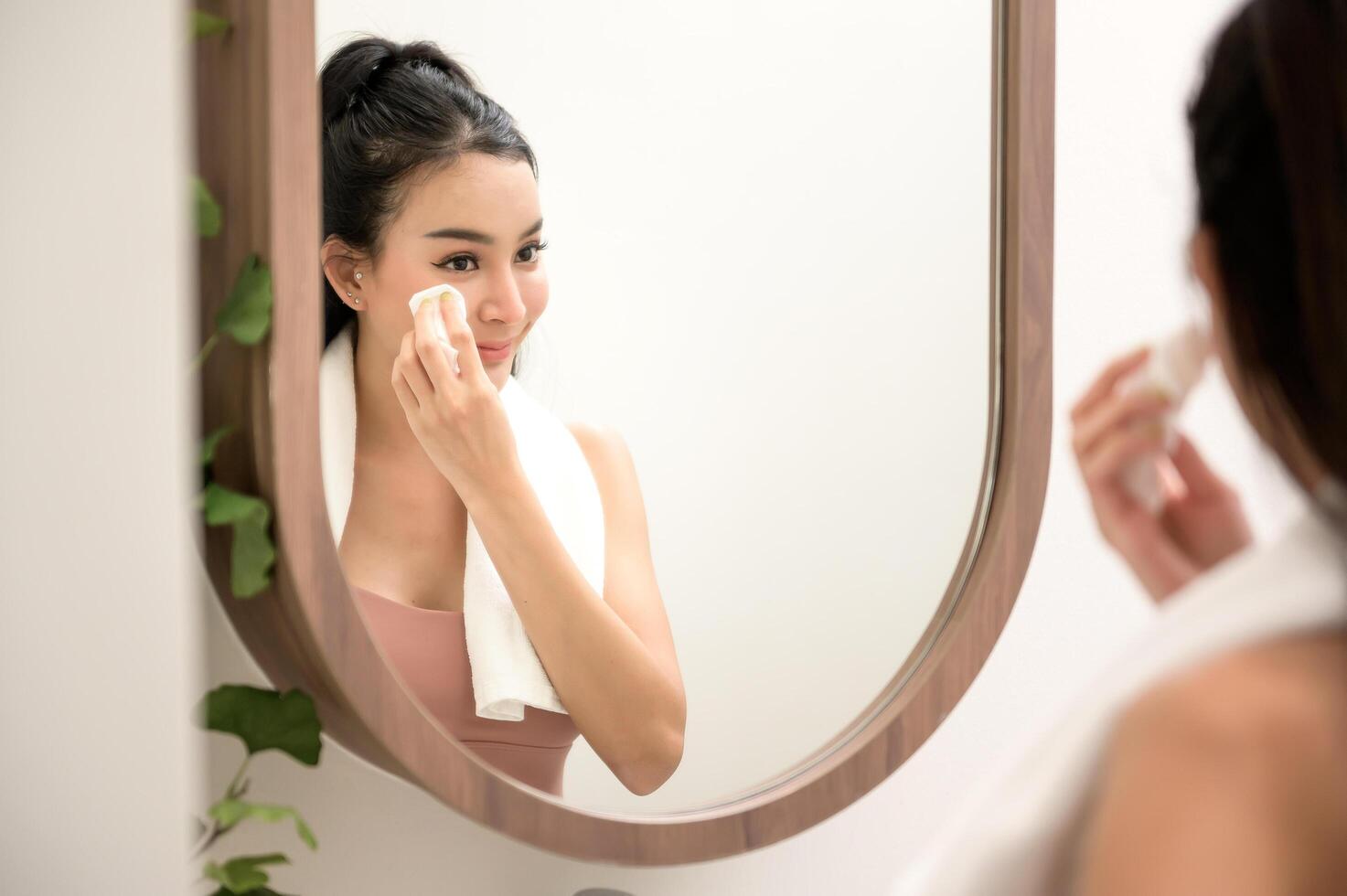 Beautiful asian woman is washing and cleaning her face photo