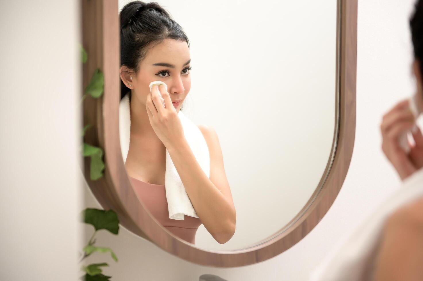 Beautiful asian woman is washing and cleaning her face photo