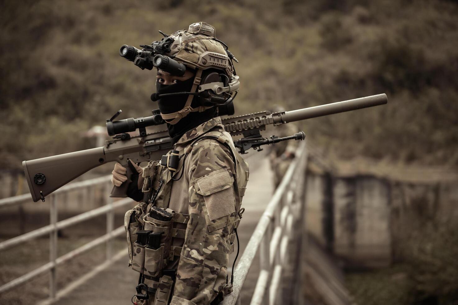 Soldiers  in camouflage uniforms aiming with their riflesready to fire during Military Operation in the forest soldiers training  in a military operation photo