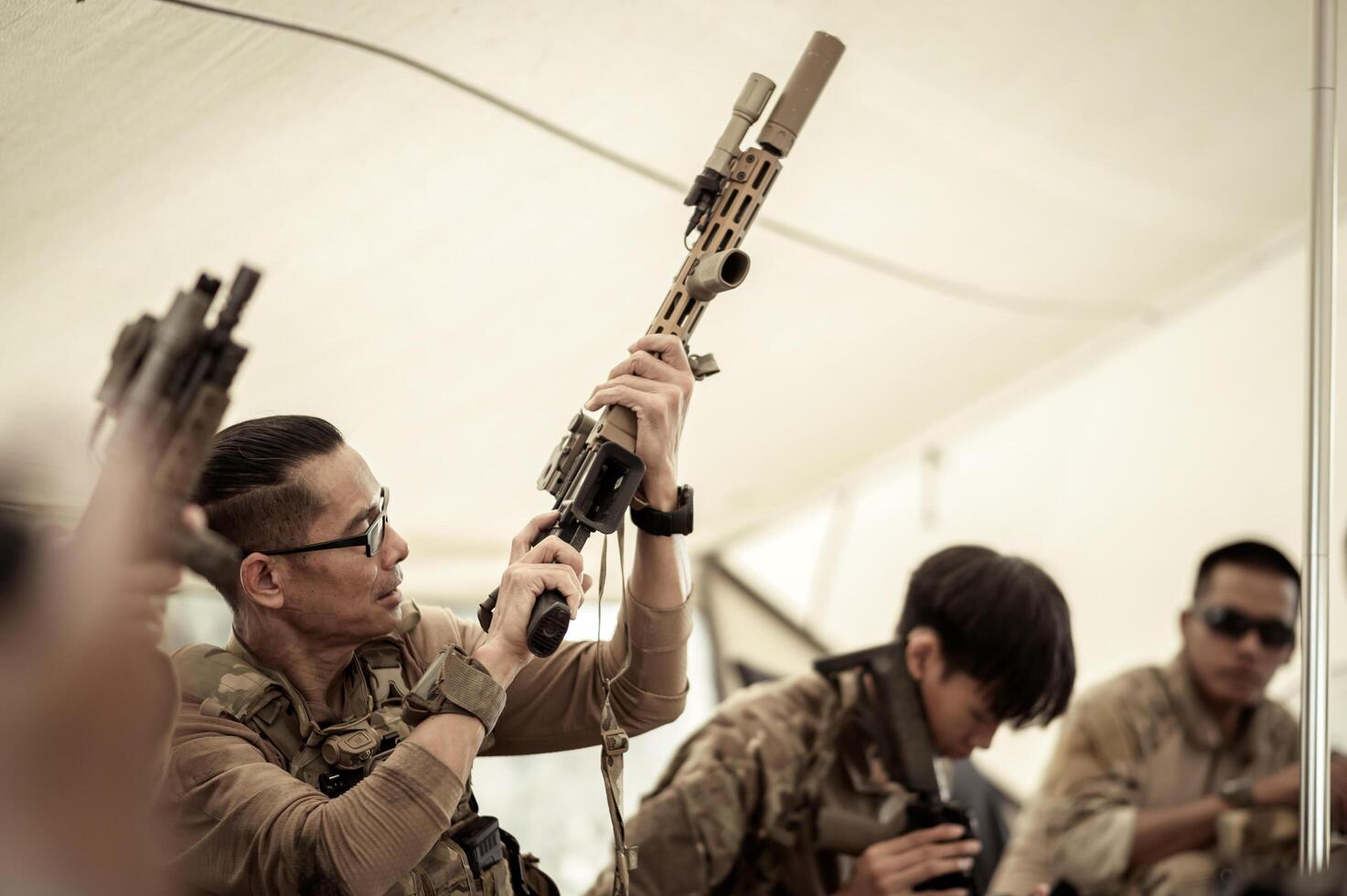 Soldiers in camouflage uniforms planning on operation in the camp, soldiers training in a military operation photo